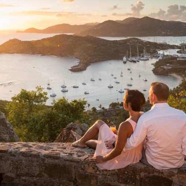 Couple relaxing looking over on Shirley Heights in Antigua