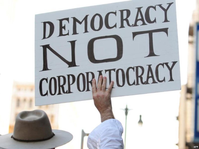 Man holding up democracy sign