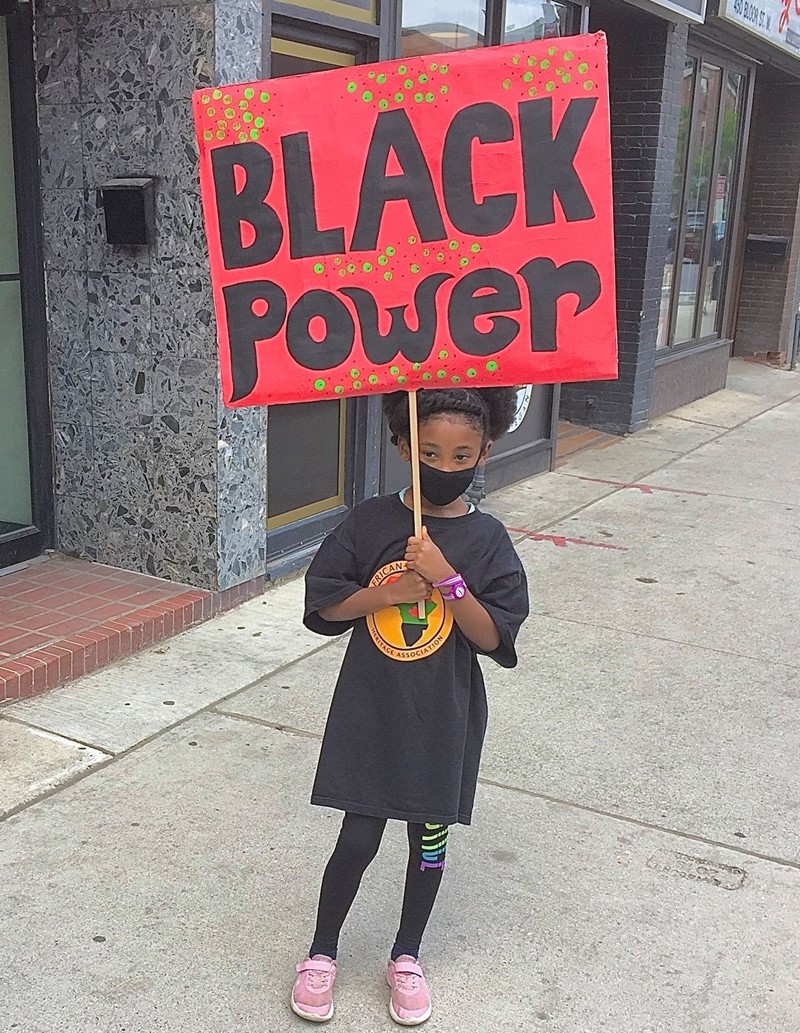 Girl Holding black power placard