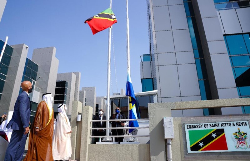 Prime Minister Dr. the Hon. Timothy Harris raises the National Flag of St. Kitts and Nevis outside of the Federation's new Embassy in Abu Dhabi, United Arab Emirates