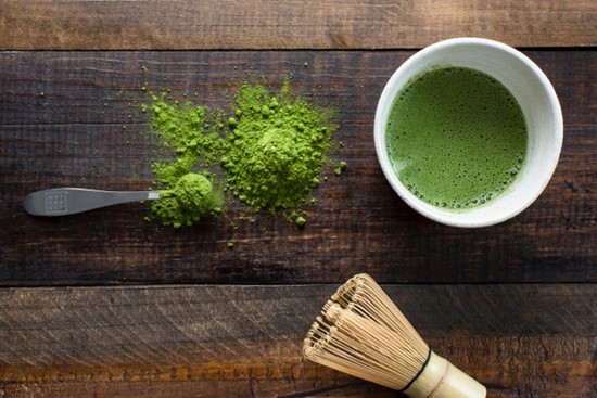 Green tea being prepared on a table